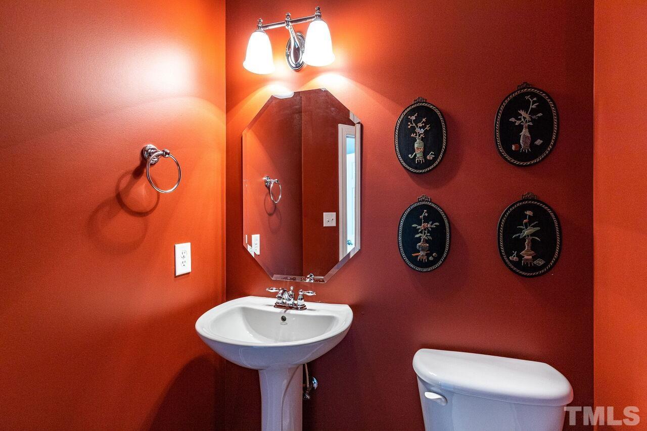 3512 Edgemont Drive Raleigh, NC 27612 - Photo 17 of 30 a bathroom with a toilet a sink and a mirror