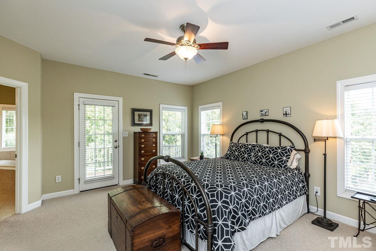 3512 Edgemont Drive Raleigh, NC 27612 - Photo 18 of 30 a bedroom with bed window and ceiling fan
