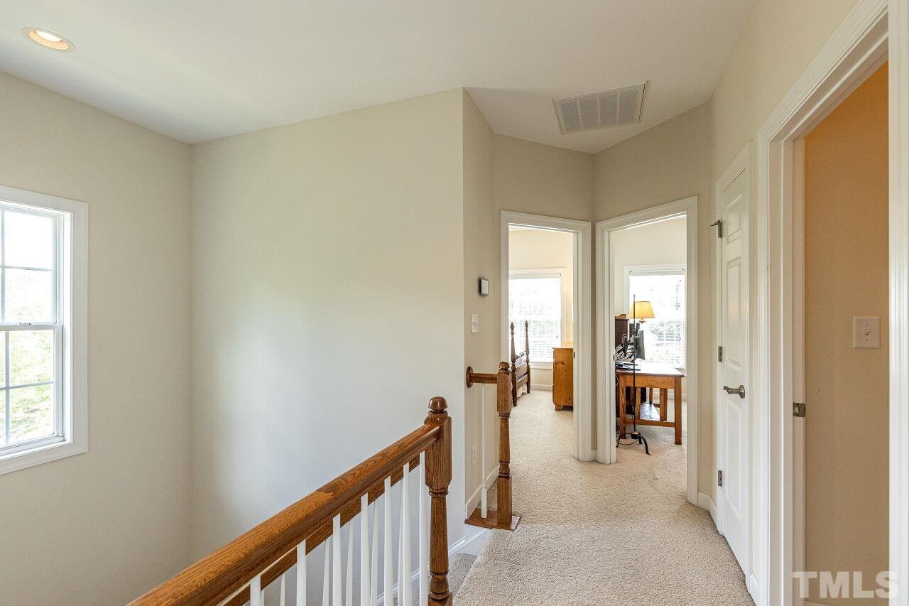 3512 Edgemont Drive Raleigh, NC 27612 - Photo 23 of 30 a view of a hallway with a livingroom and furniture
