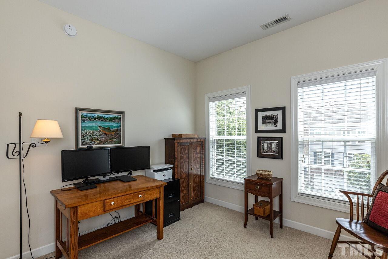 3512 Edgemont Drive Raleigh, NC 27612 - Photo 25 of 30 a living room with furniture a window and a flat screen tv