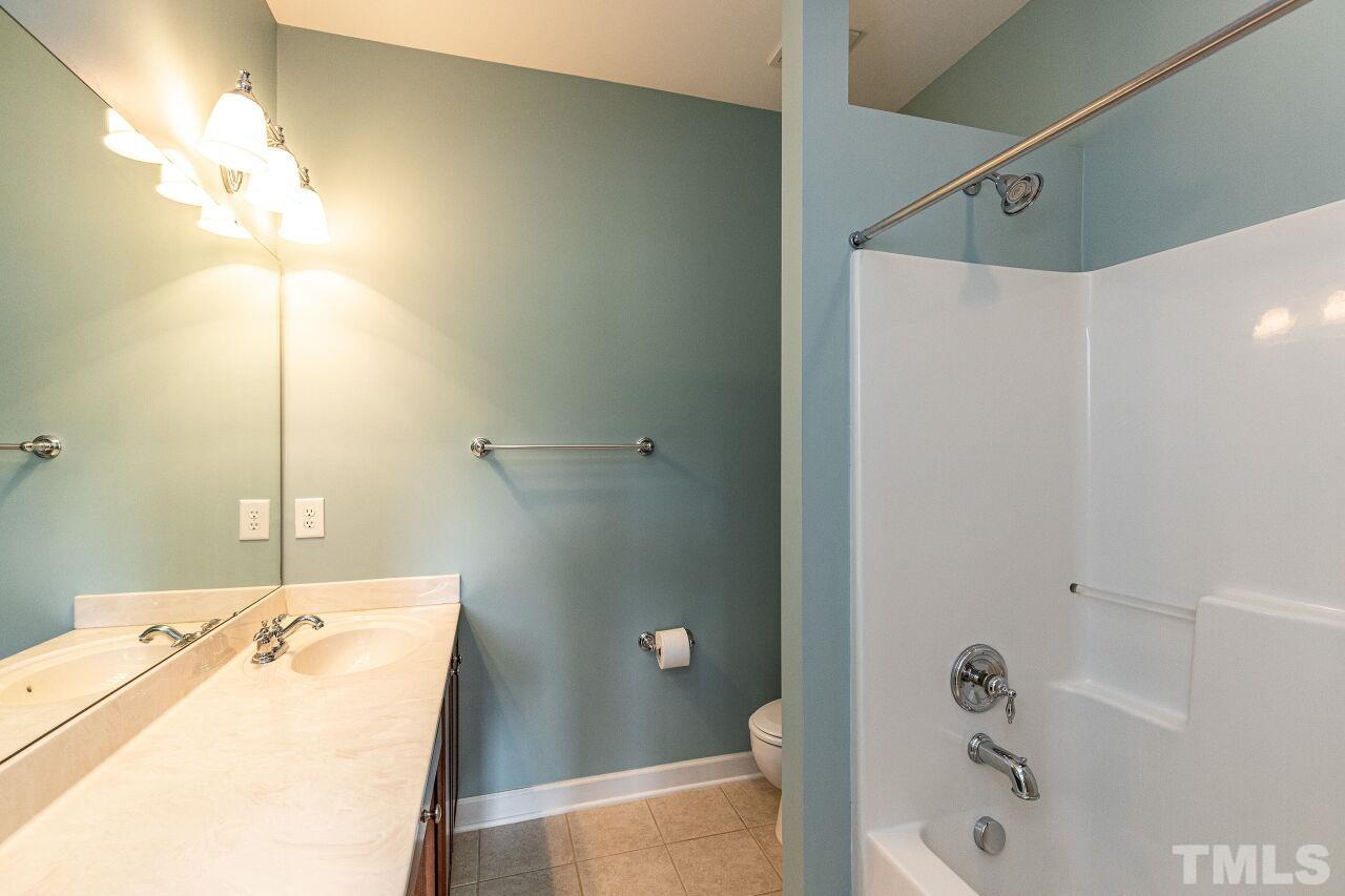 3512 Edgemont Drive Raleigh, NC 27612 - Photo 26 of 30 a bathroom with a sink a mirror and a shower