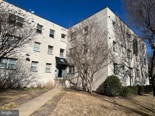 a view of a tall building with a snow in the background