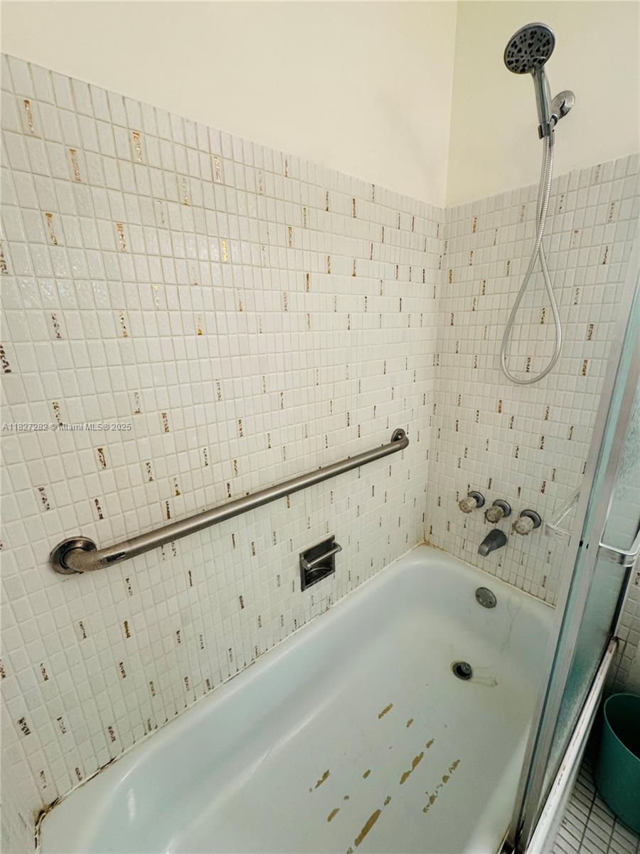 5641 Southwest 2nd Court, Unit 210 Margate, FL 33068 - Photo 16 of 36 a bathroom with bathtub and shower