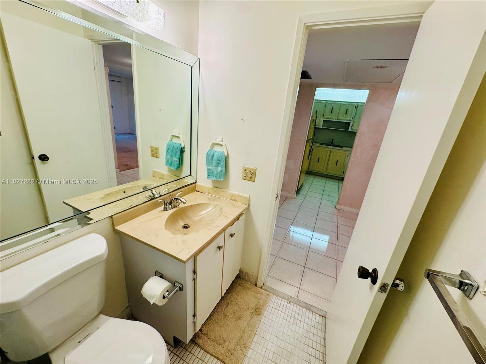 5641 Southwest 2nd Court, Unit 210 Margate, FL 33068 - Photo 17 of 36 a bathroom with a toilet sink and mirror