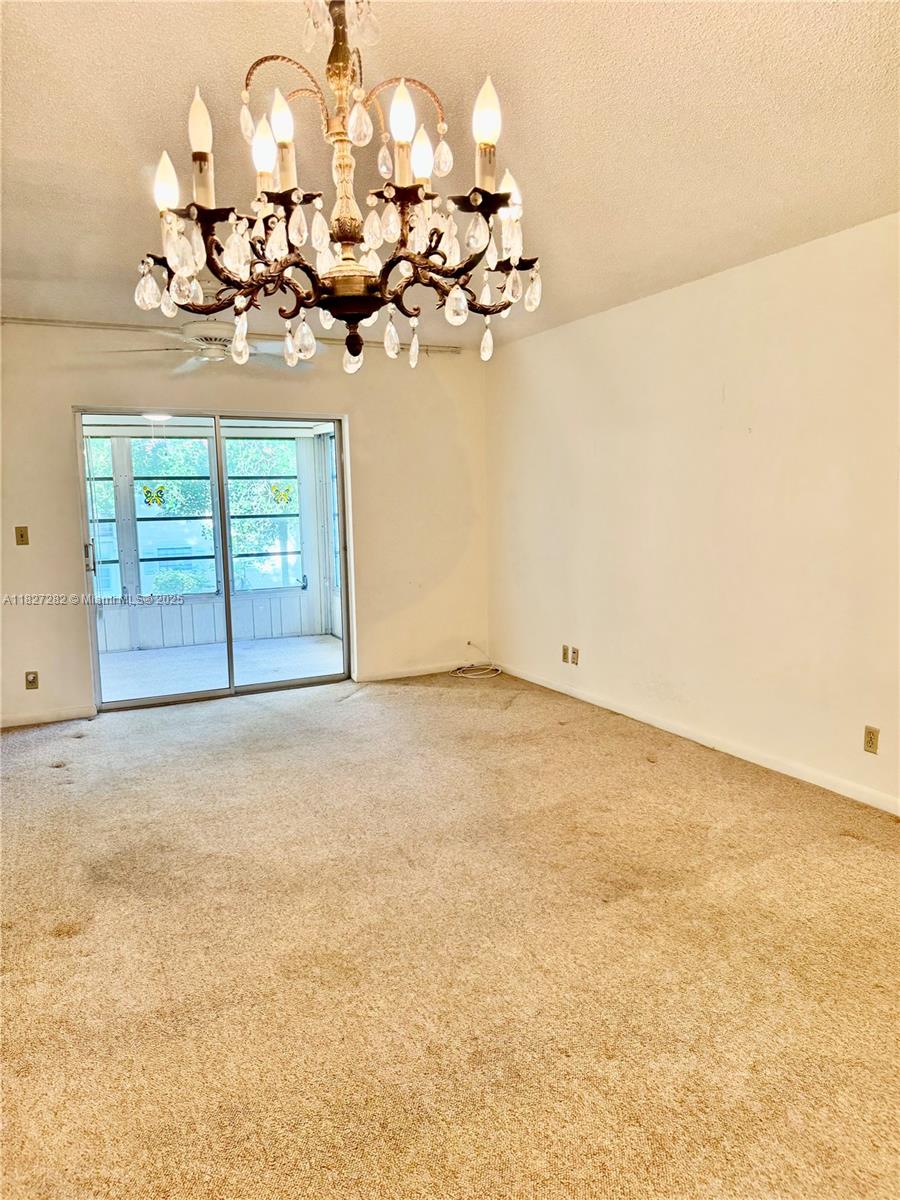 5641 Southwest 2nd Court, Unit 210 Margate, FL 33068 - Photo 22 of 36 en view of a room with a chandelier fan and windows