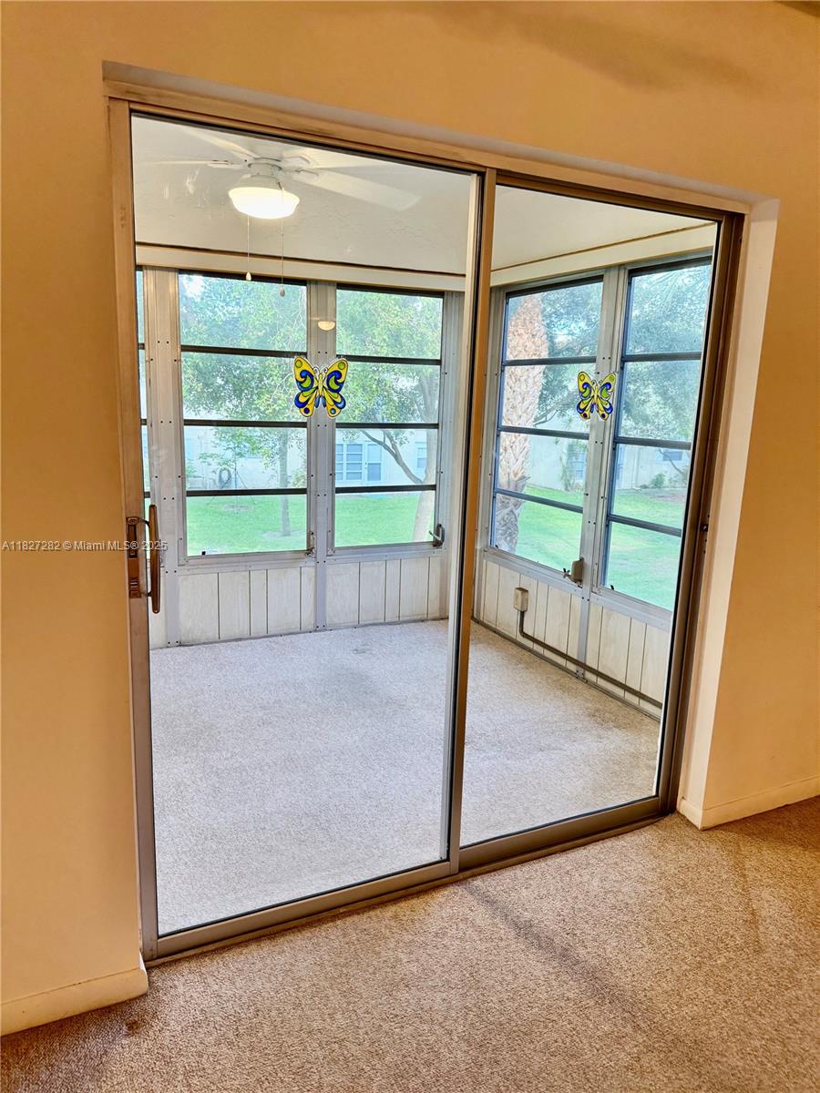 5641 Southwest 2nd Court, Unit 210 Margate, FL 33068 - Photo 23 of 36 an empty room with sliding door and wooden floor