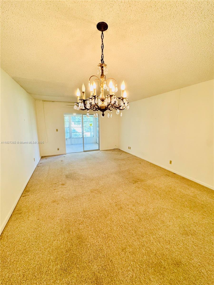 5641 Southwest 2nd Court, Unit 210 Margate, FL 33068 - Photo 5 of 36 a view of a room with window and chandelier