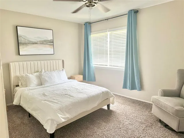 a bedroom with a bed couch and window