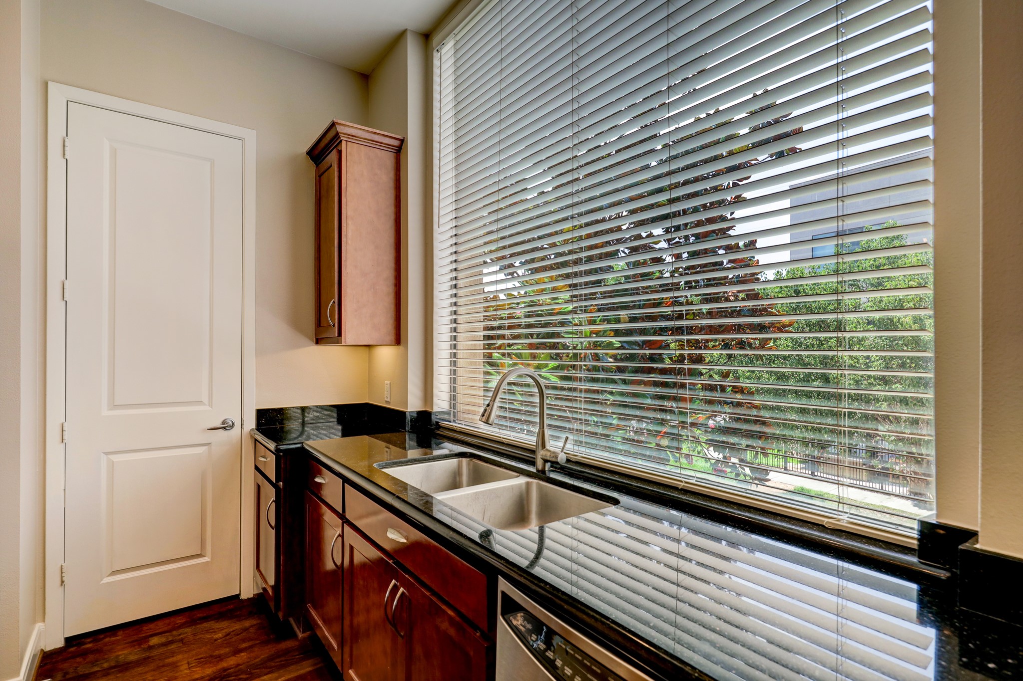 5202 Rose Street, Unit B Houston, TX 77007 - Photo 15 of 40 Bright kitchen with large windows, granite countertops, and modern wood cabinetry. Great natural light and views outside.