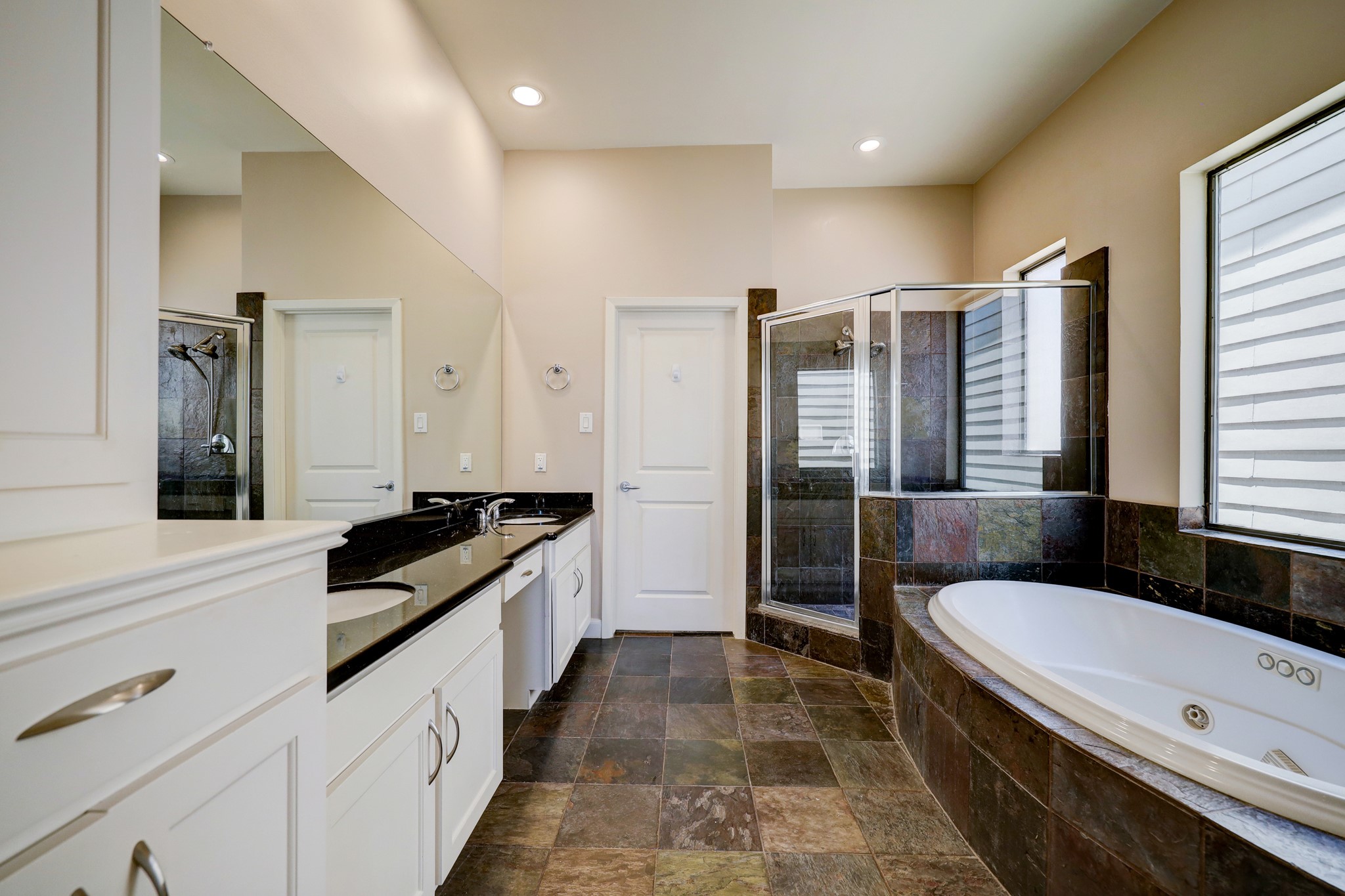 5202 Rose Street, Unit B Houston, TX 77007 - Photo 24 of 40 Spacious bathroom featuring a modern double vanity, large corner shower, and a luxurious soaking tub. Natural light enhances the sleek design and finishes.