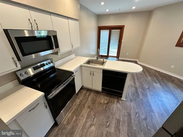 a kitchen with a sink appliances and cabinets