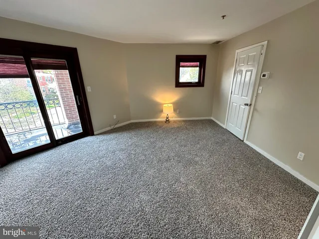 an empty room with windows and closet