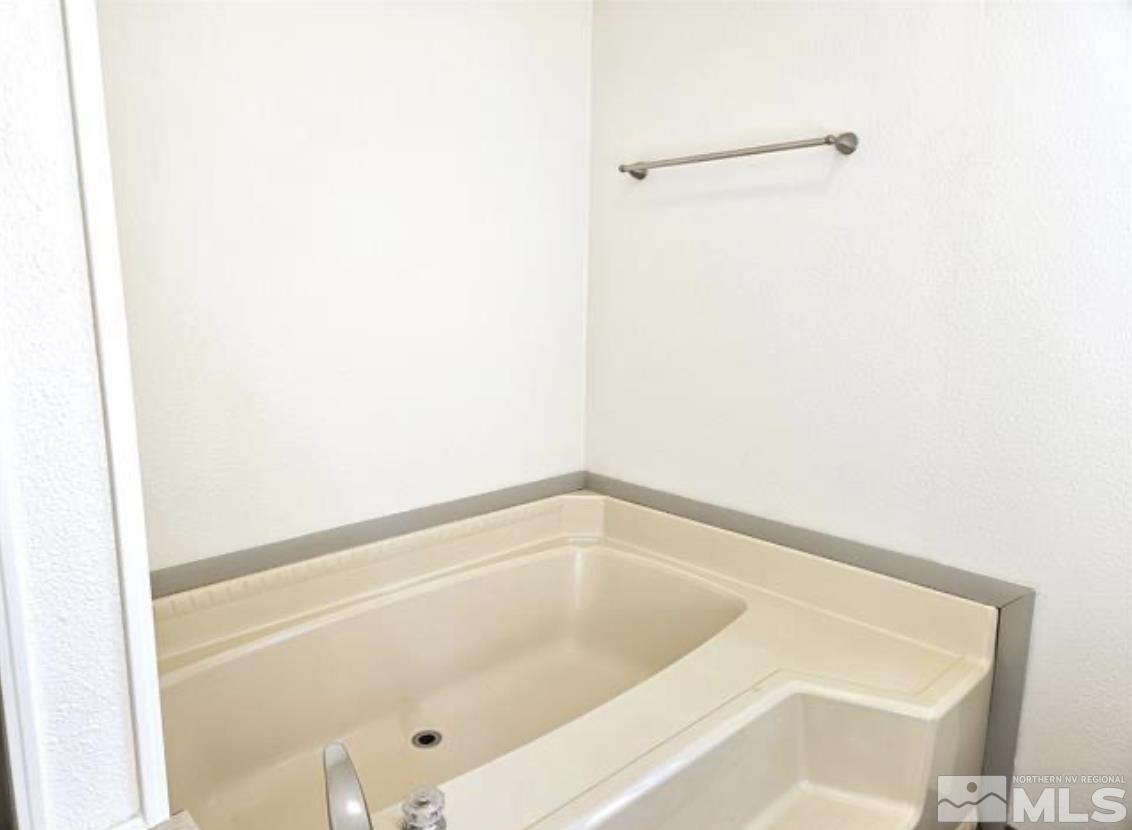 16355 Rhyolite Circle Reno, NV 89521 - Photo 19 of 26 a bath tub sitting next to a white sink
