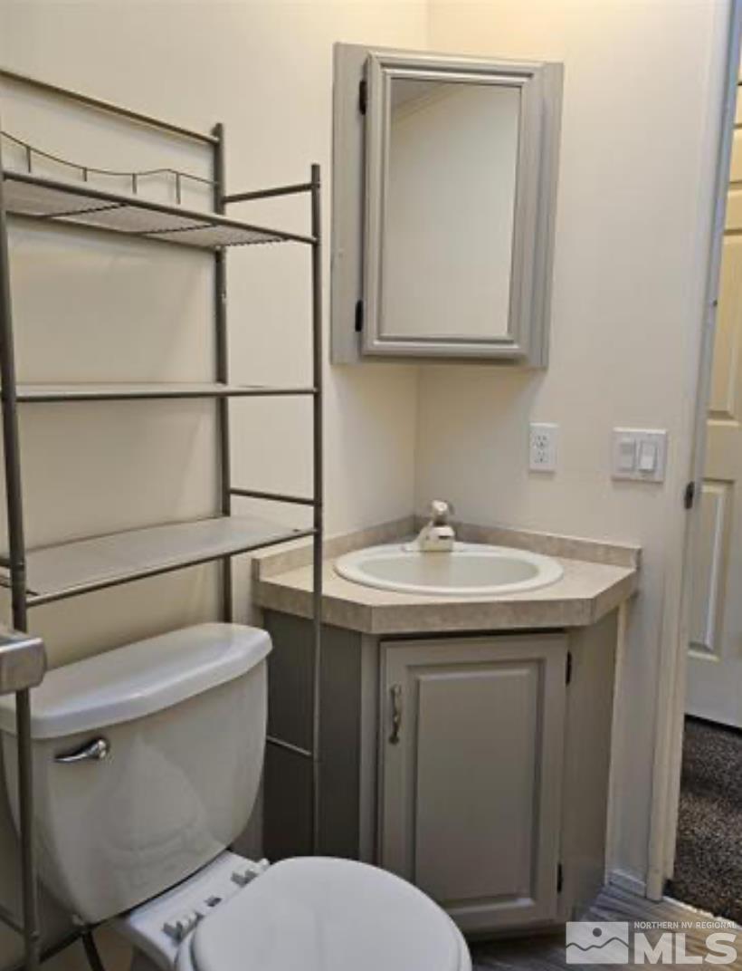 16355 Rhyolite Circle Reno, NV 89521 - Photo 21 of 26 a bathroom with a sink a toilet and mirror