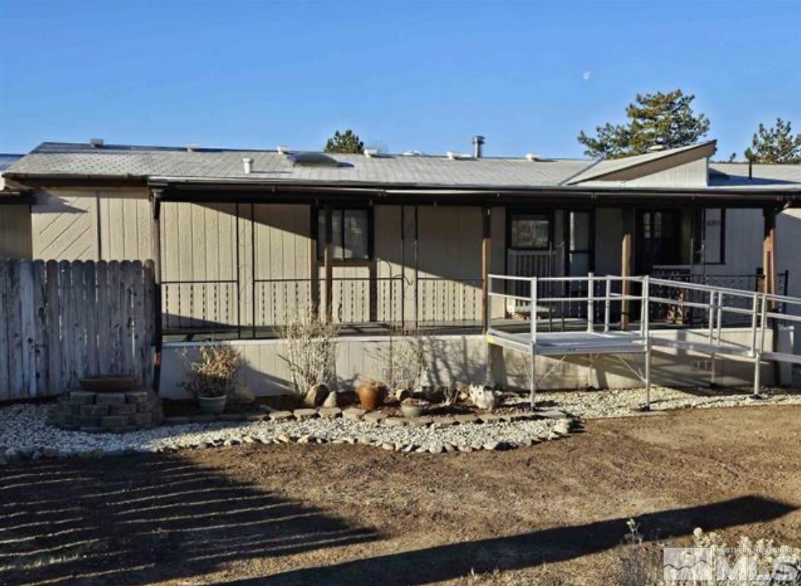 16355 Rhyolite Circle Reno, NV 89521 - Photo 4 of 26 a view of a house with a wooden fence