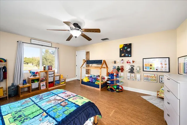 a bedroom with furniture and a large window