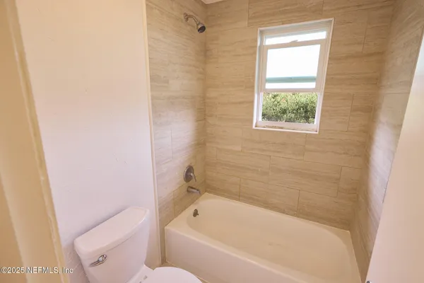 an aerial view of residential houses with outdoor space and swimming pool