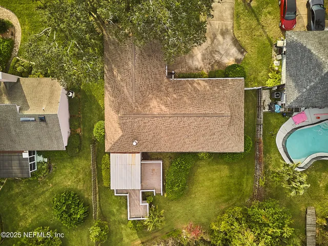 an aerial view of residential houses with outdoor space