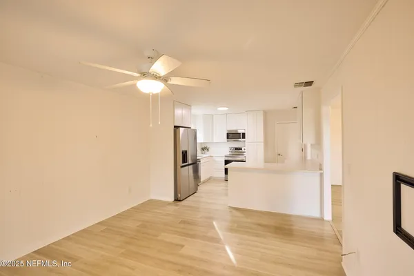a kitchen with stainless steel appliances a refrigerator sink and microwave