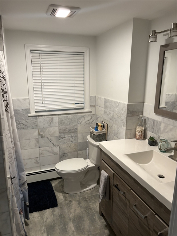 55 Fox Hill Road, Unit 1 Nahant, MA 01908 - Photo 2 of 9 a bathroom with a sink toilet and mirror