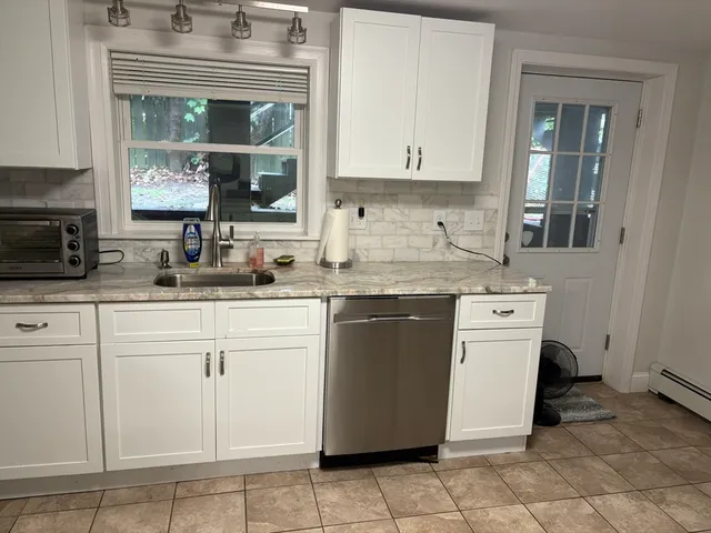 a kitchen with a sink stove and cabinets