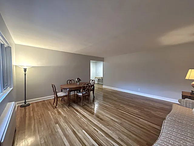 a dining room with furniture and wooden floor