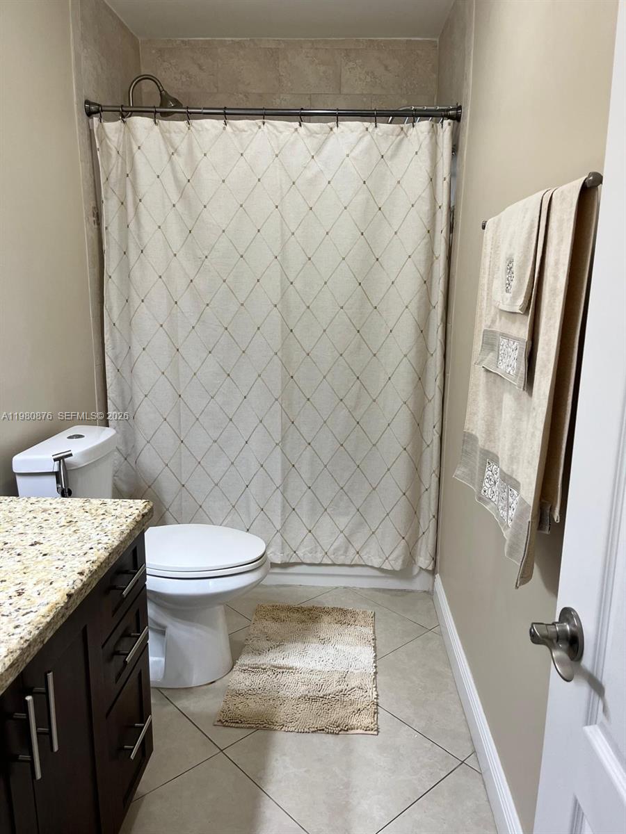 685 West 77th Street Hialeah, FL 33014 - Photo 25 of 35 a bathroom with a granite countertop toilet and a sink