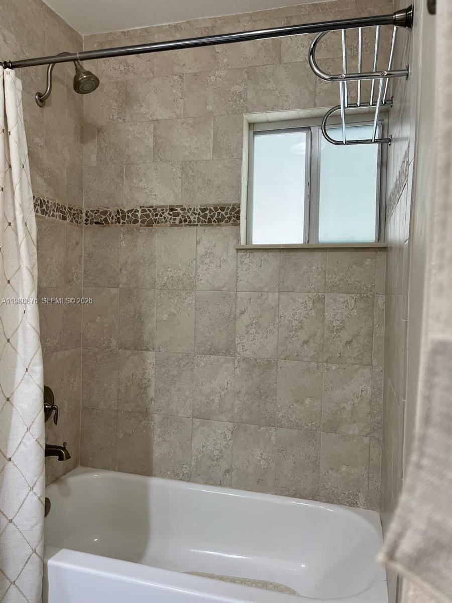 685 West 77th Street Hialeah, FL 33014 - Photo 27 of 35 a bathroom with a shower and a bathtub