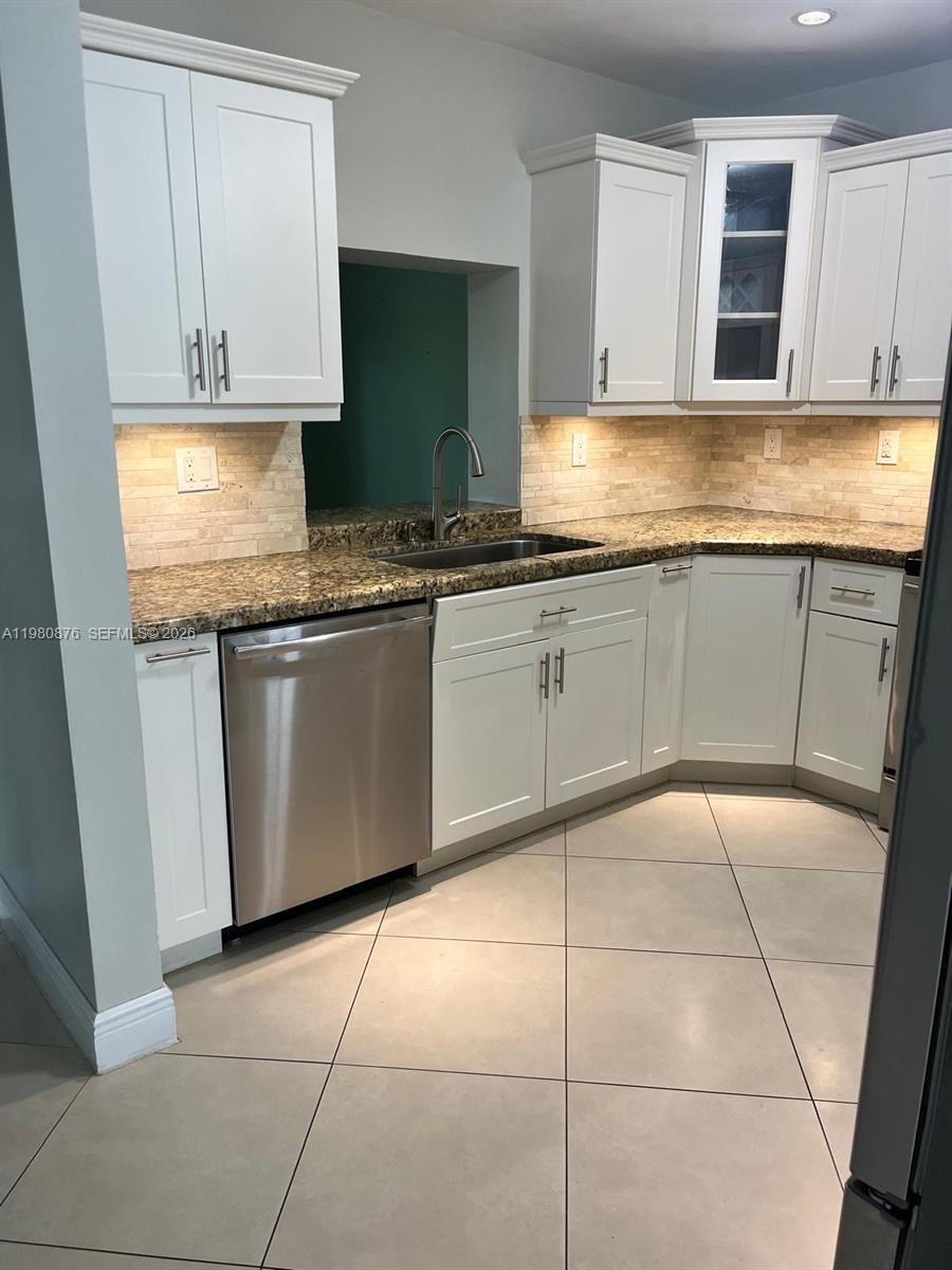 685 West 77th Street Hialeah, FL 33014 - Photo 8 of 35 a kitchen with granite countertop a sink and cabinets