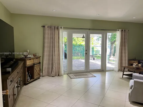 a spacious bathroom with a mirror a bathtub and next to a window
