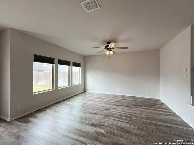 a view of kitchen with kitchen island wooden floor center island and stainless steel appliances
