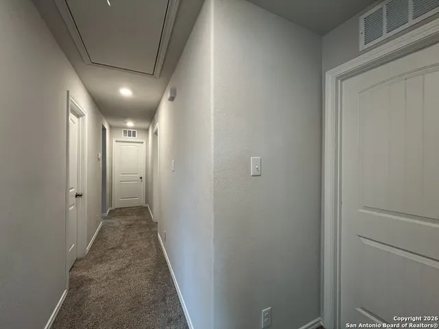 an empty room with a ceiling fan and a window