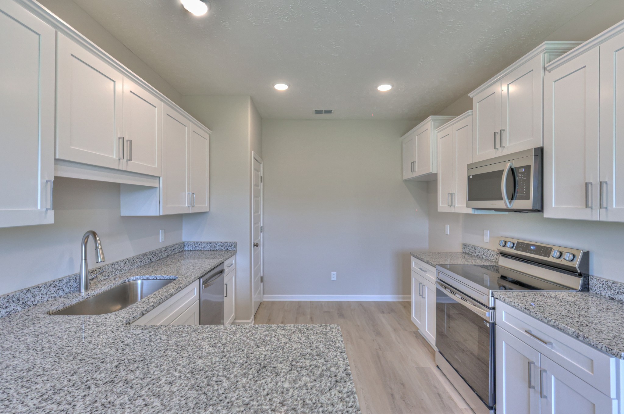 201 North Fork Branch Road Tullahoma, TN 37388 - Photo 16 of 31 a kitchen with granite countertop a sink a stove and cabinets