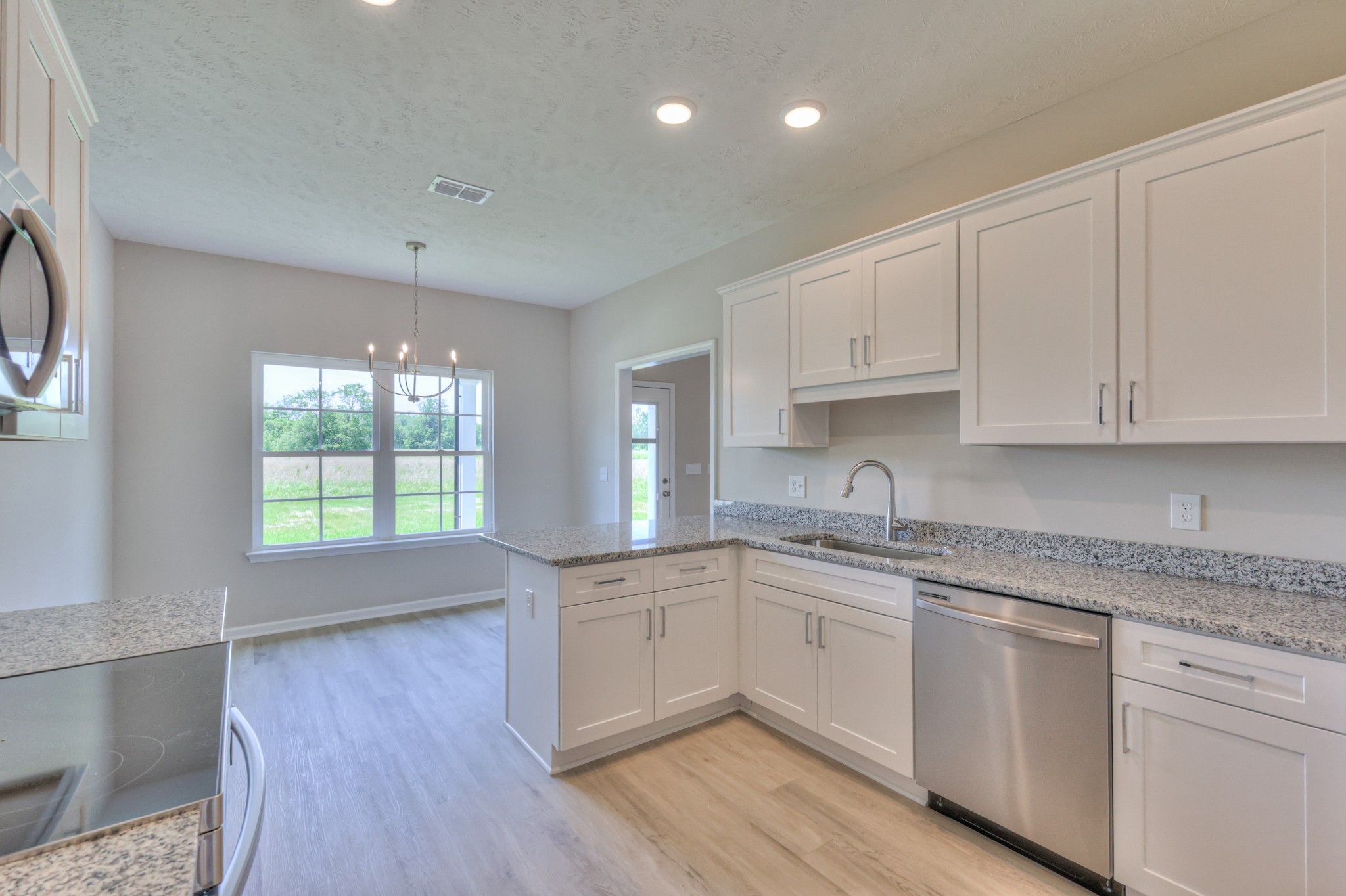 201 North Fork Branch Road Tullahoma, TN 37388 - Photo 17 of 31 a kitchen with granite countertop white cabinets and white appliances