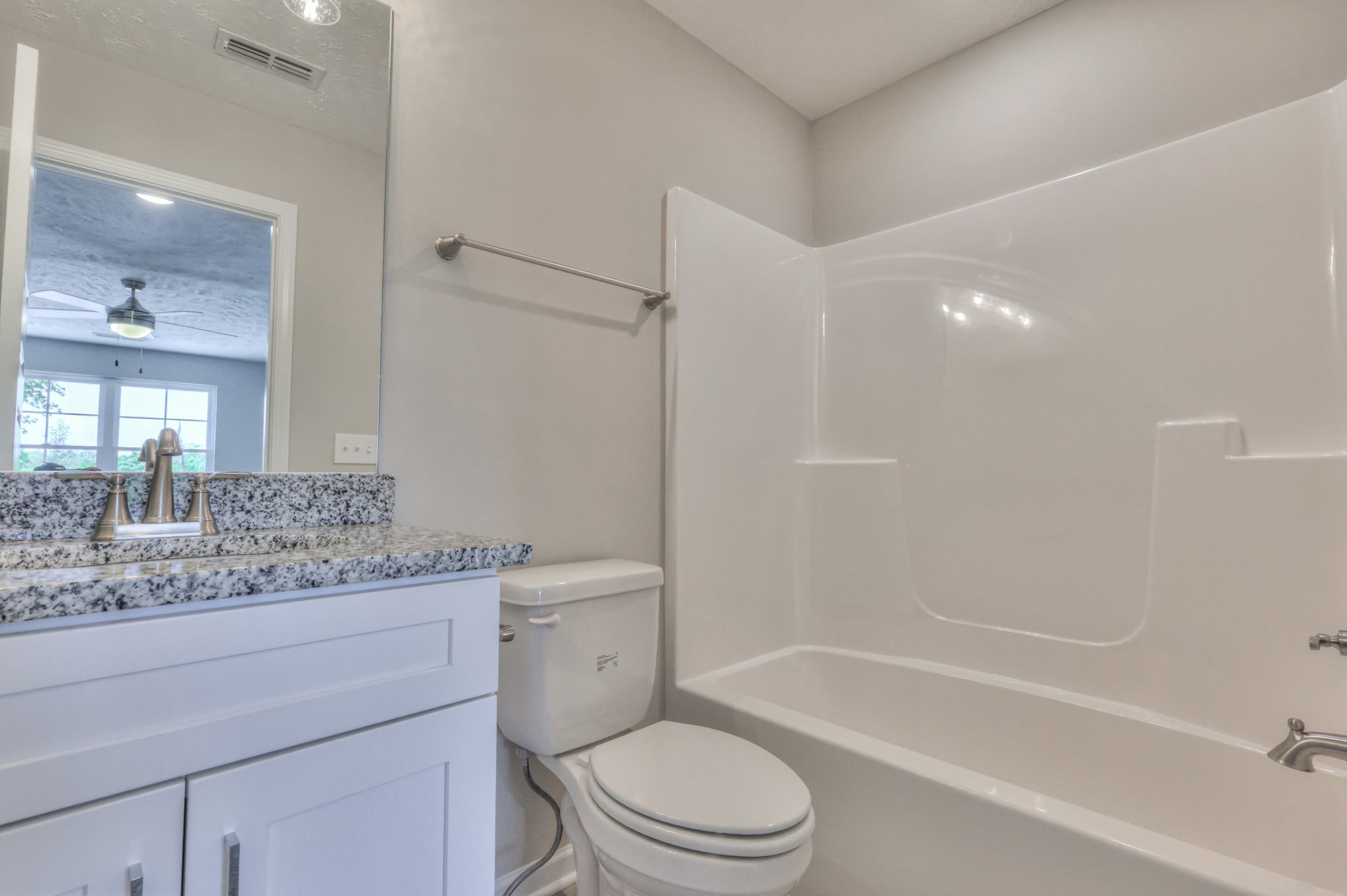 201 North Fork Branch Road Tullahoma, TN 37388 - Photo 26 of 31 a bathroom with a granite countertop sink a toilet and bathtub