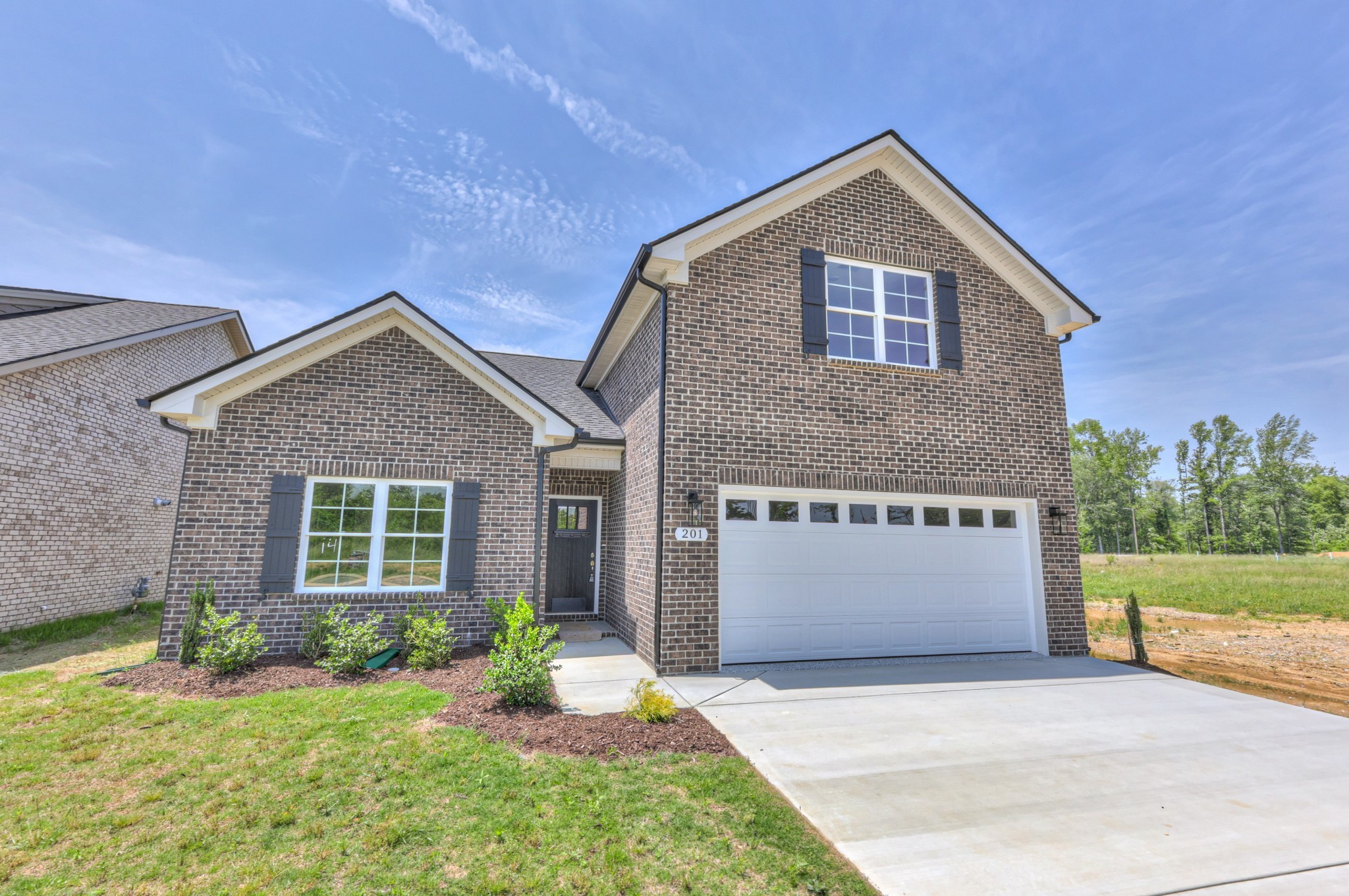 201 North Fork Branch Road Tullahoma, TN 37388 - Photo 4 of 31 a front view of a house with a yard and garage