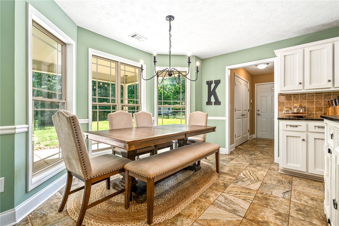 1284 Lee Road Salem, AL 36874 - Photo 9 of 24 This bright dining area features ample natural light and a tiled floor, perfect for gatherings.