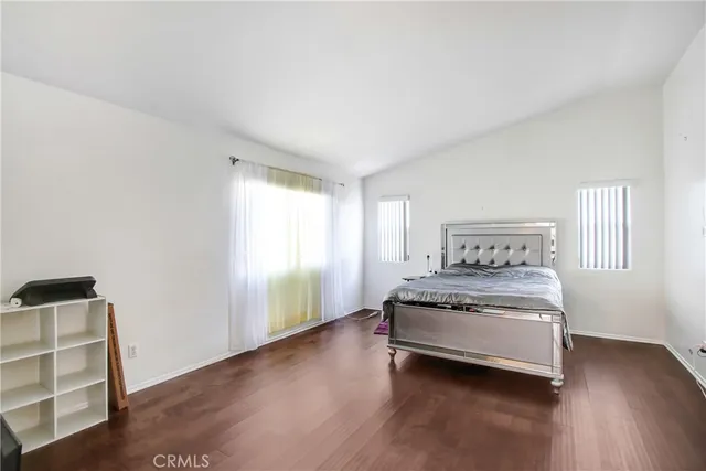 a spacious bedroom with a bed and a window