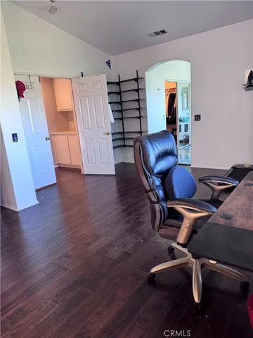 a view of a workspace with furniture and wooden floor