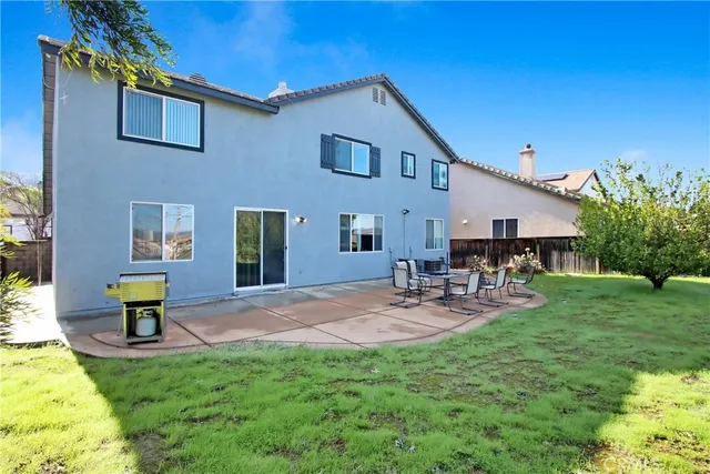 a front view of a house with patio and garden