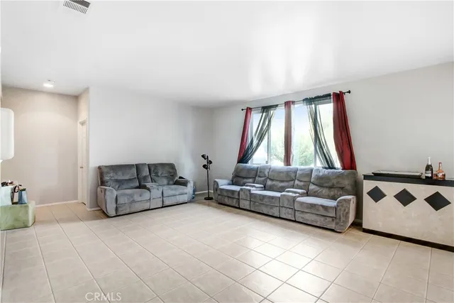 a living room with furniture and a floor to ceiling window