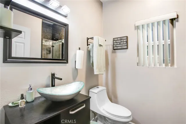 a white toilet sitting next to a bathroom sink