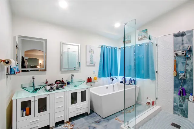 a white bath tub sitting in a bathroom and sink