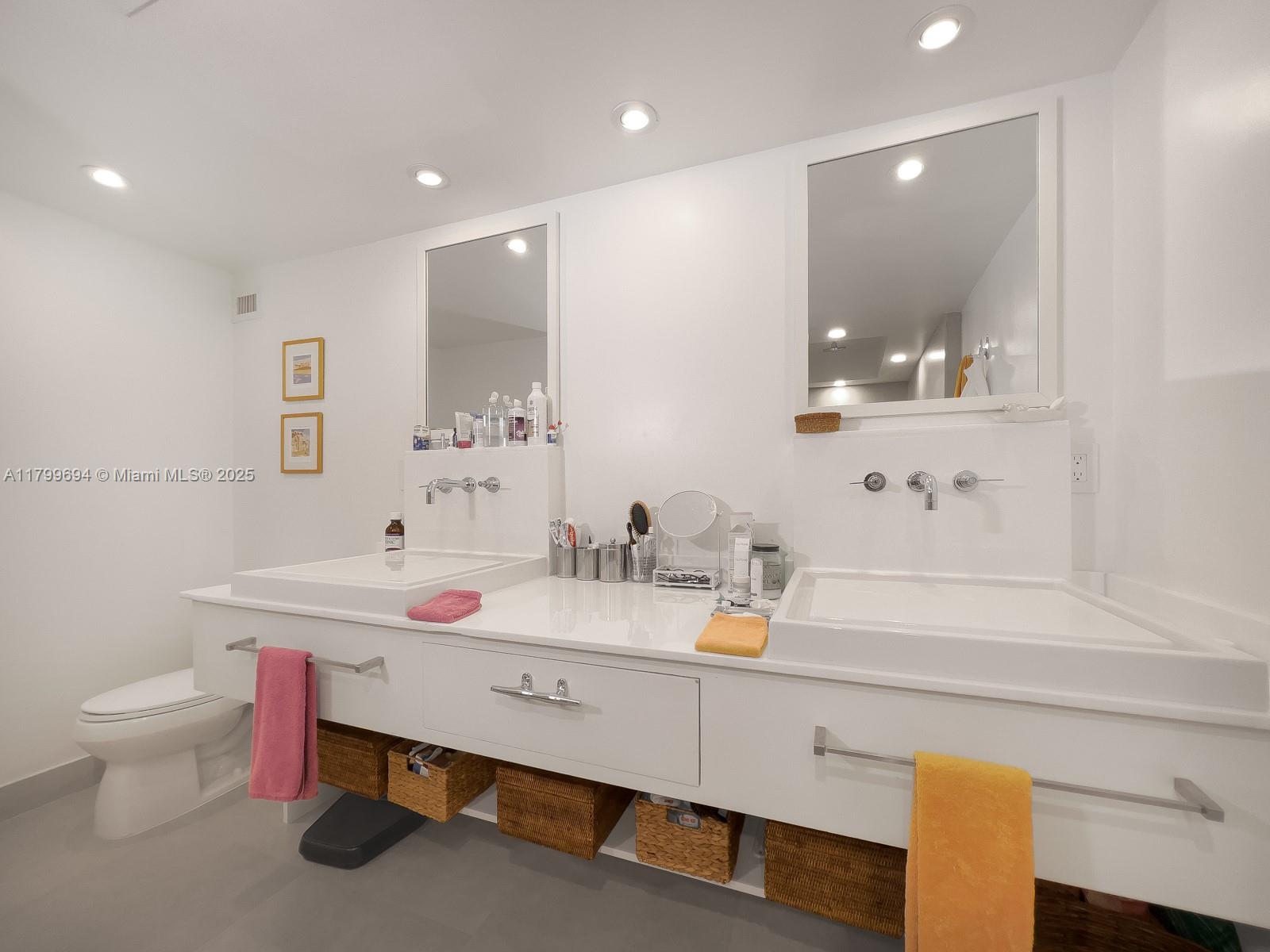 1121 Crandon Boulevard, Unit E307 Key Biscayne, FL 33149 - Photo 15 of 30 a bathroom with a sink vanity mirror and toilet