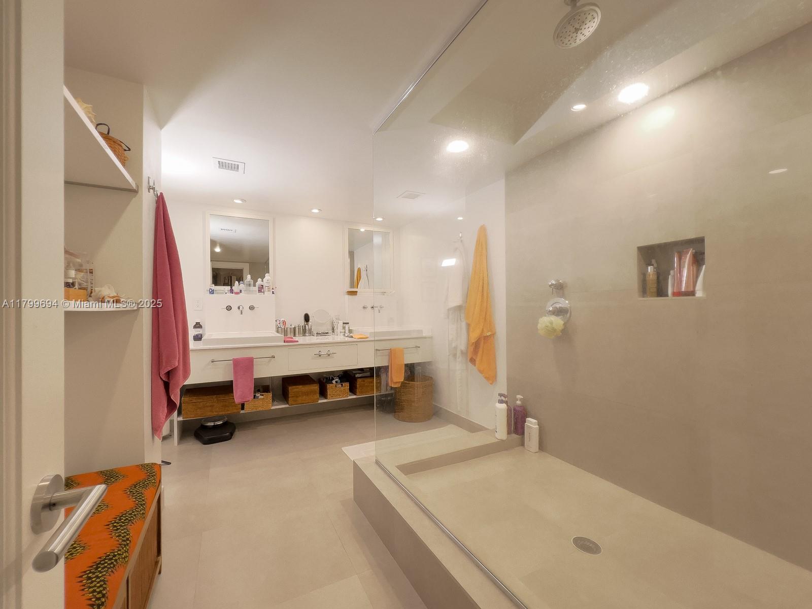 1121 Crandon Boulevard, Unit E307 Key Biscayne, FL 33149 - Photo 16 of 30 a bathroom with a tub sink and mirror