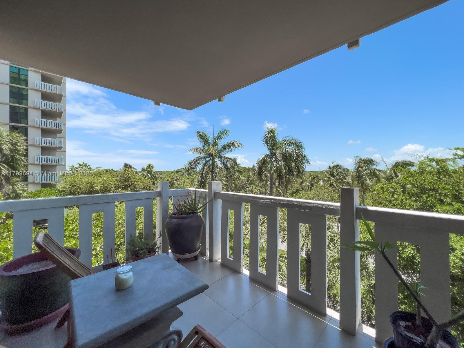 1121 Crandon Boulevard, Unit E307 Key Biscayne, FL 33149 - Photo 21 of 30 a view of a balcony with chairs