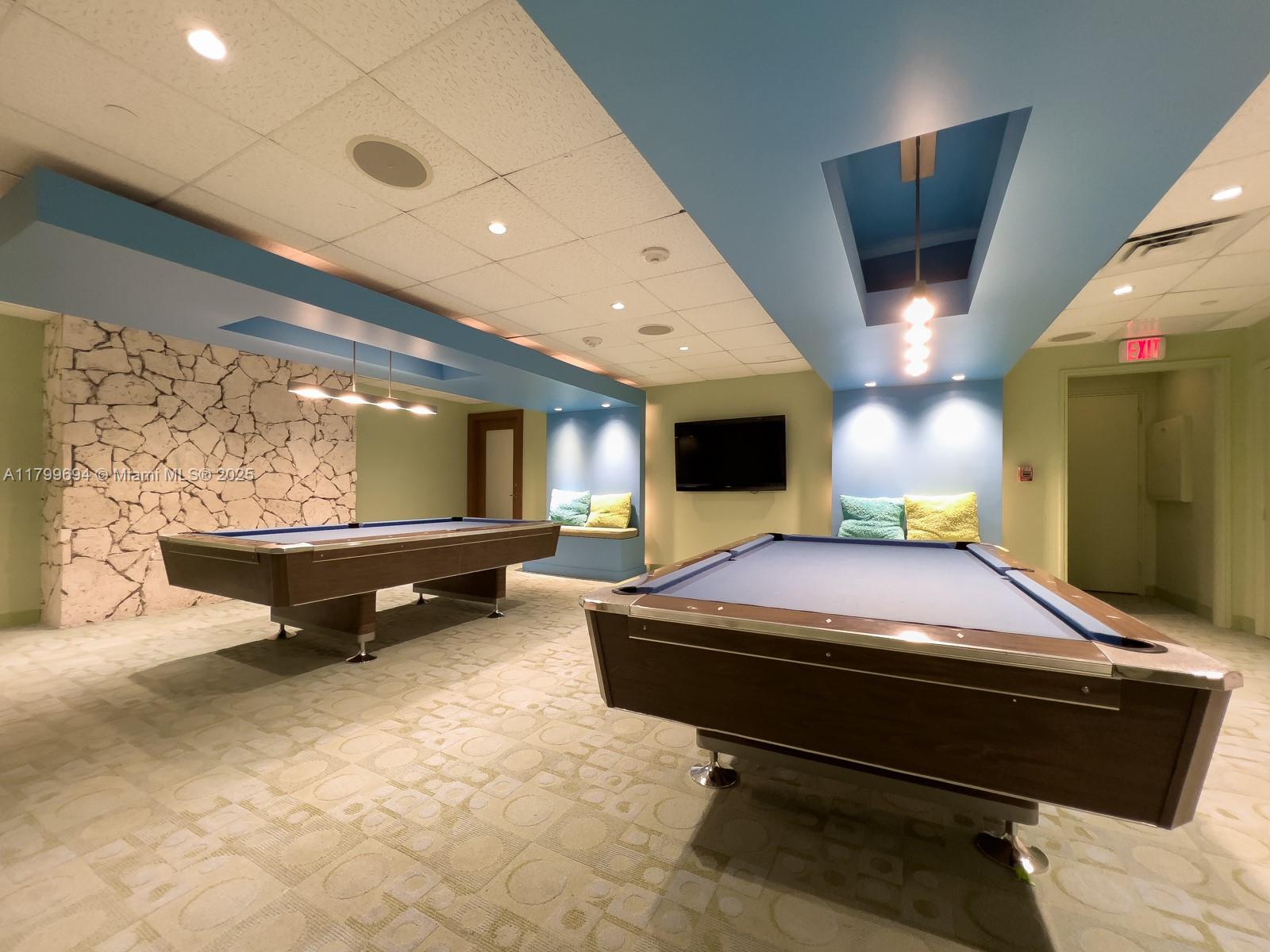 1121 Crandon Boulevard, Unit E307 Key Biscayne, FL 33149 - Photo 23 of 30 a room with furniture and flat screen tv