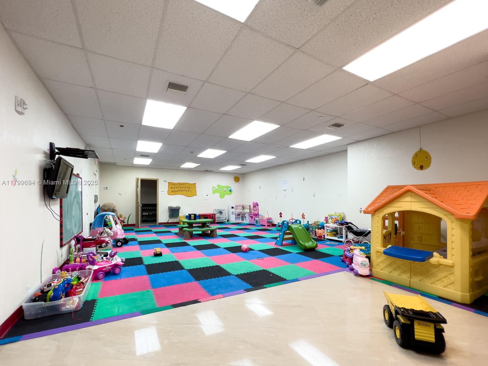 1121 Crandon Boulevard, Unit E307 Key Biscayne, FL 33149 - Photo 24 of 30 a room with toys and flat screen tv