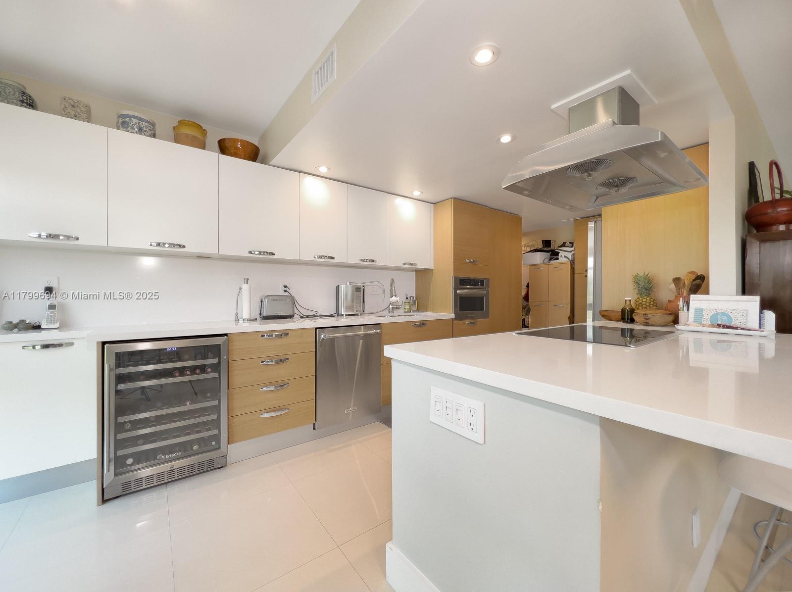 1121 Crandon Boulevard, Unit E307 Key Biscayne, FL 33149 - Photo 3 of 30 a kitchen with cabinets appliances and a counter space