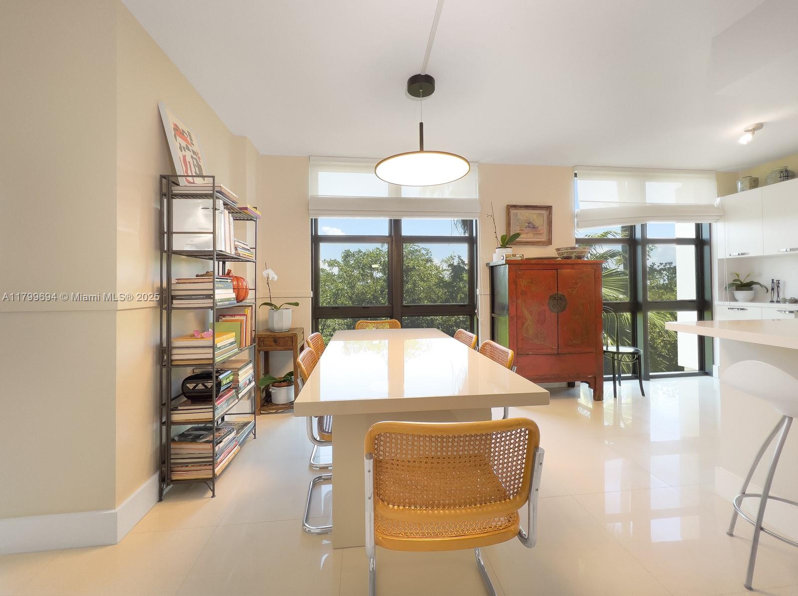 1121 Crandon Boulevard, Unit E307 Key Biscayne, FL 33149 - Photo 9 of 30 a living room with fireplace furniture and a large window